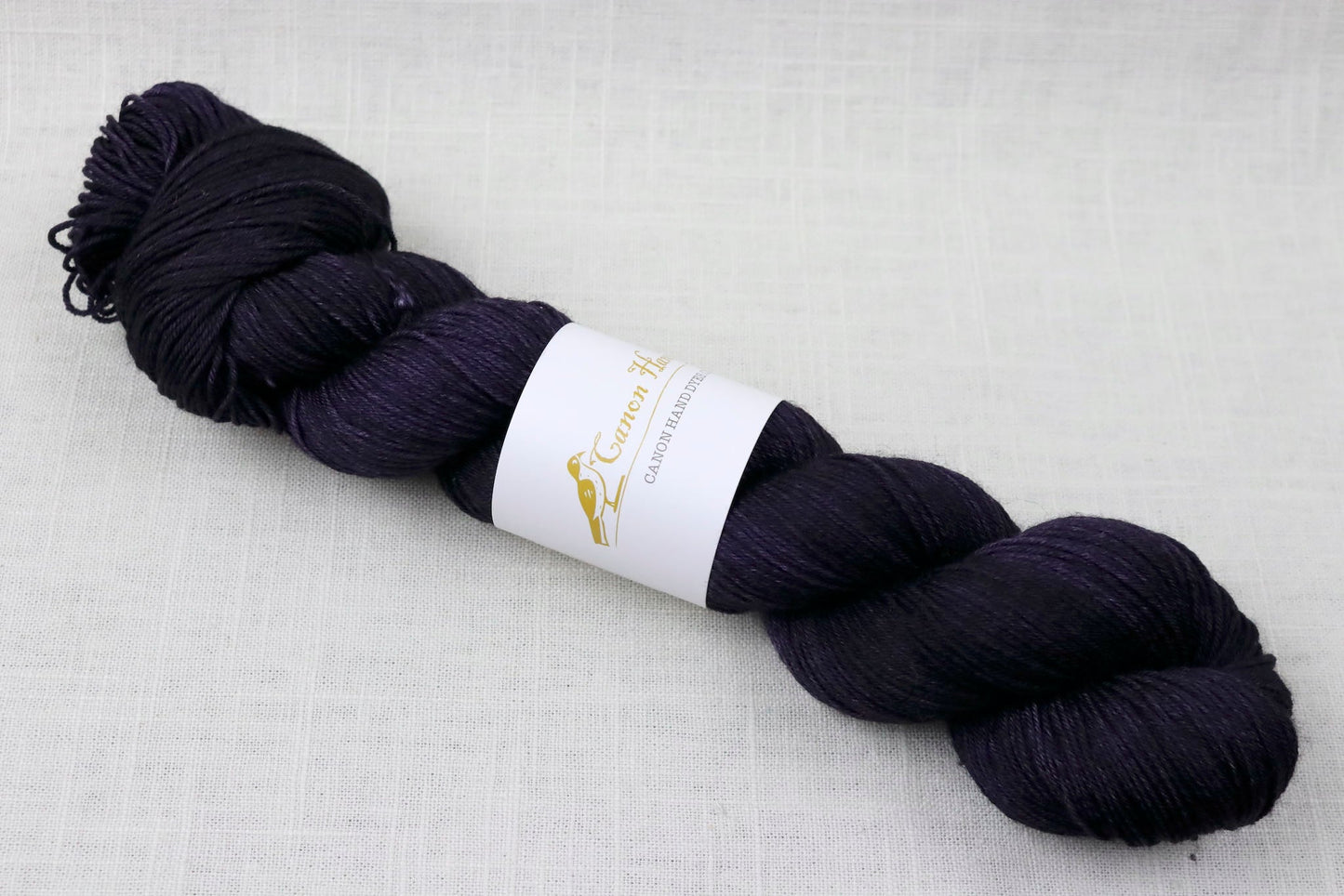 canon hand dyes john merino fingering madame delacroix dark purple, almost black